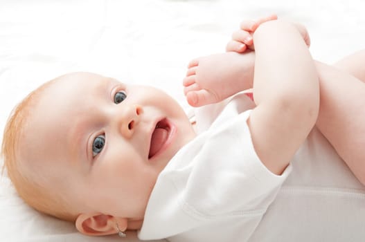Cute Baby Girl Sucking Her Toes on White Background