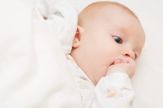 Baby Lying on Back Sucking its Hand