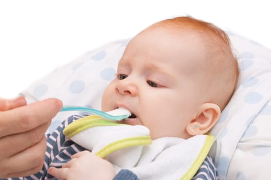 Closeup of  Baby Girl Feeding With a Spoon