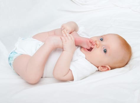 Cute Baby Girl Sucking Her Toes on White Background