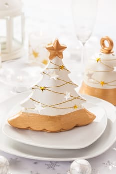Festive table for Christmas in white and golden tones