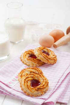 Christmas cookies with glass of milk and baking ingredients