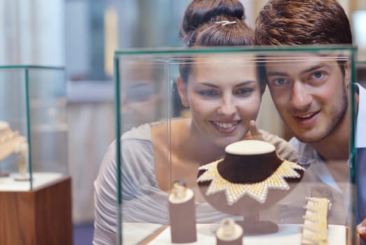 happy young romantic couple in love buy jewelry ring in luxury store