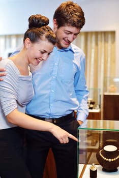 happy young romantic couple in love buy jewelry ring in luxury store