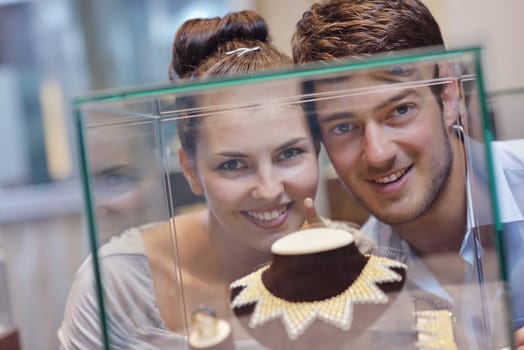 happy young romantic couple in love buy jewelry ring in luxury store