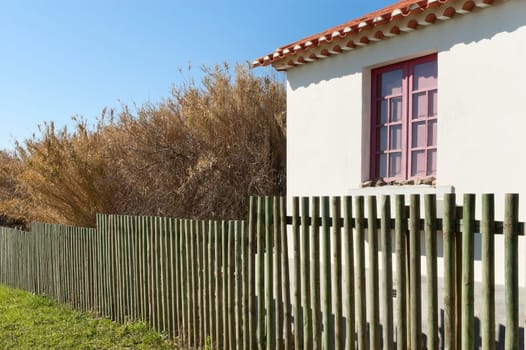Wooden fence next a country house