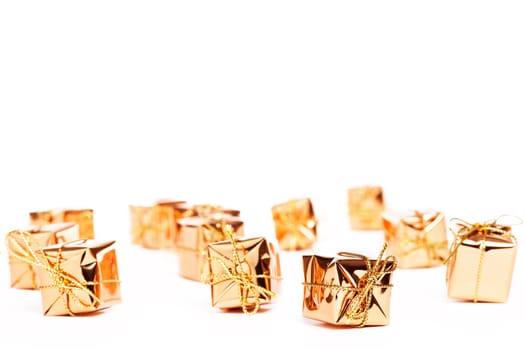 Small golden christmas gifts on white background