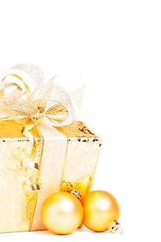 Golden Christmas gift with golden baubles on white background