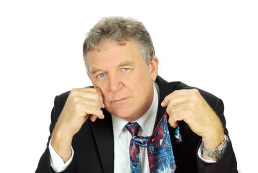Middle aged depressed businessman looking frustrated holding his tie.
