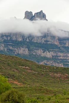 Montserrat mountain and valley fog. Famous mountain of Catalonia, Spain