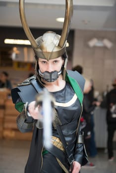 LONDON, UK - OCTOBER 27: Cosplayer impersonating the character Loki poses for photographers at the London Comicon MCM Expo. Most participants dress up in superhero costumes to compete in the Euro Cosplay Championship. October 27, 2012 in London.