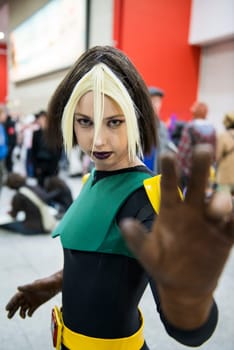 LONDON, UK - OCTOBER 27: Cosplayer impersonating super heroine Rogue poses for photographers at the London Comicon MCM Expo. Most participants dress up in superhero costumes to compete in the Euro Cosplay Championship. October 27, 2012 in London.