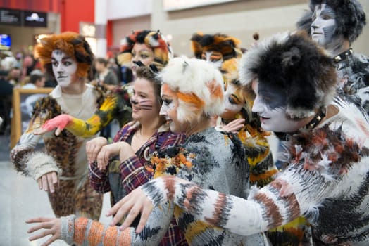 LONDON, UK - OCTOBER 27: Cosplayers impersonating the musical Cats pose for photographers at the London Comicon MCM Expo. Most participants dress up in superhero costumes to compete in the Euro Cosplay Championship. October 27, 2012 in London.