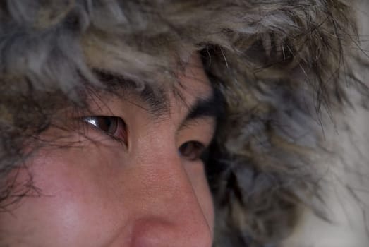 closeup of asian or inuit looking man with coat above his head, in outline
