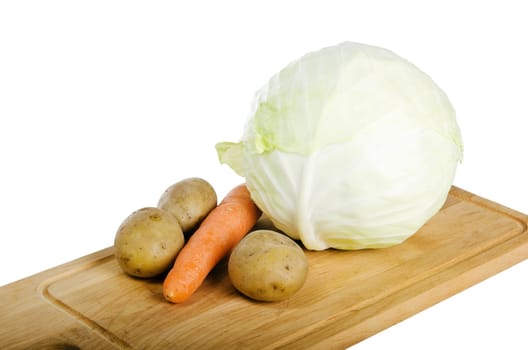 Fresh vegetables on a kitchen Board isolated on white