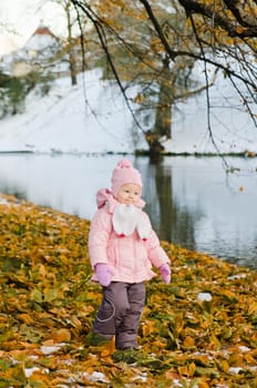 A little girl walks in autumn Park
