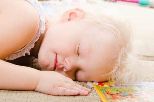 little girl fell asleep after playing