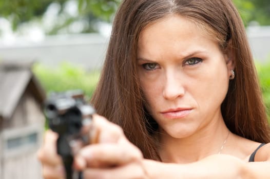 A woman has her hangun out on the range