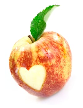Luscious red apple with a heart cutout in the skin signifying love of fresh healthy organic fruit