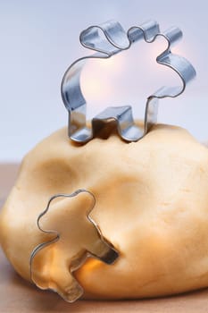 Pastry for festive animal cookies with metal cookie cutters on a kitchen table ready to bake seasonal Christmas biscuits to celebrate the holiday