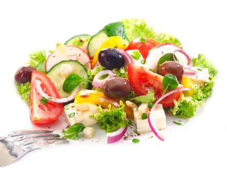 Serving of delicious Greek salad with crisp greens, feta, olives, tomato and onion garnished with orange peel