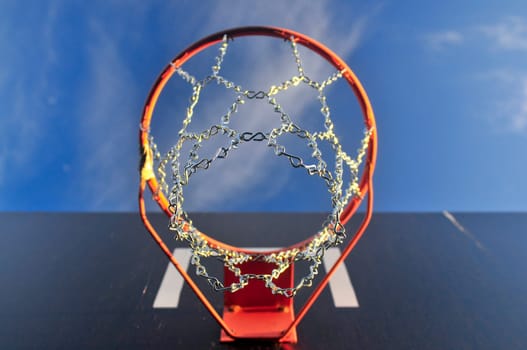 Basketball ring outside with sky and cloud