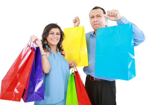 Couple at shopping ,the young woman it is very happy and laughing with bags in her hands while the man it is sad,bored or tired of shopping