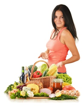 Young woman with variety of grocery products including vegetable, fruits, meat, dairy and wine