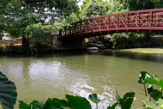 A rusty and old bridge over water