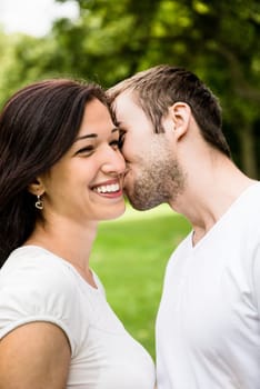Young happy couple kissing - outdoor lifestyle portrait