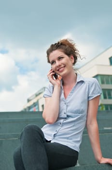 Young beautiful smiling woman calling with mobile phone