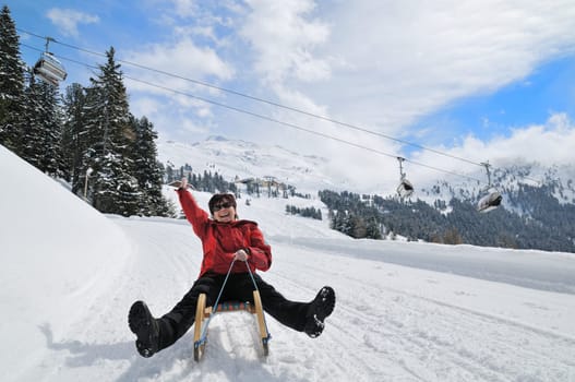 Winter people series - senior woman on sledge having fun in white snowy country