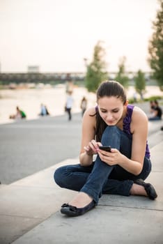 Young smiling woman with mobile phone ( touchscreen smartphone)