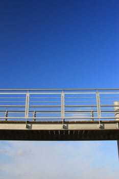 Metal walkway in front of blue sky