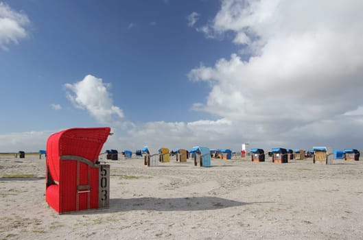 red beach chair on a beach at the North Sea