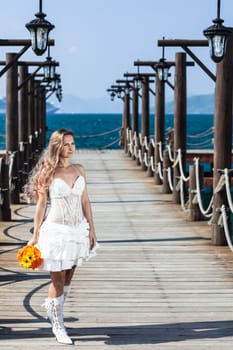Beautiful bride with wedding bouquet at the pier