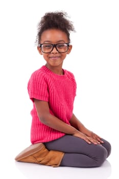 Portrait of a cute young African American girl seated on the floor
