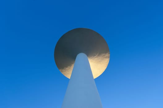 White painted water tower against a clear blue sky in the small village of S. Bartolomeu do Outeiro,  Alentejo, Portugal