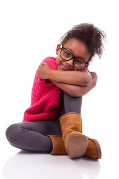 Portrait of a cute young African American girl seated on the floor