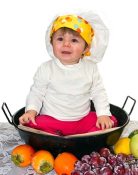 Baby cook with vegetables in studio