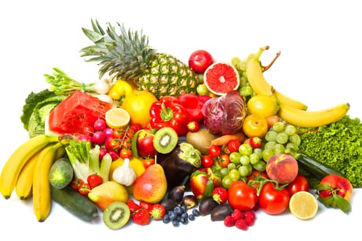 Fruits and vegetables like tomatoes, zucchini, melons, bananas and grapes arranged in a group, natural still life for healthy food
