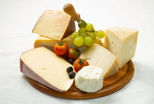 composition of different type of cheese on wooden board