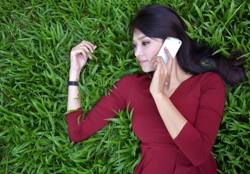 pretty woman making a phone call in the garden