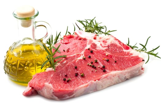 raw T-bone with rosemary on white background