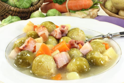 a plate of Brussels sprout stew with colorful vegetables and bacon