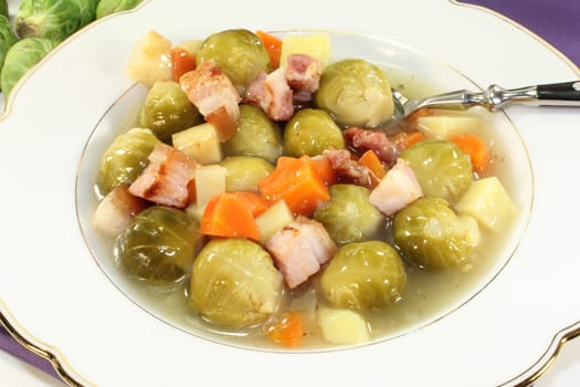 a plate of Brussels sprout stew with colorful vegetables and bacon