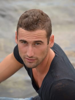 Attractive young man looking up, shot from above