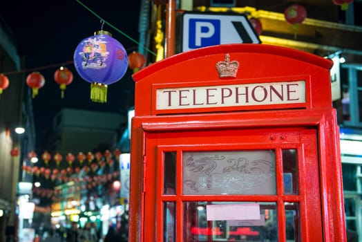 LONDON, UK - NOVEMBER 05: Detail of traditional red phone booth in Chinatown, the main Chinese commercial district in the city. November 05, 2012 in London.