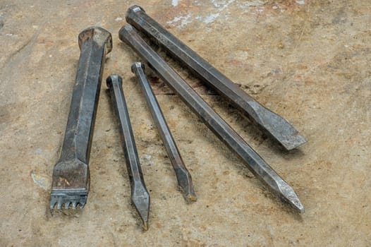 Composition of different chisels on a sandstone slab