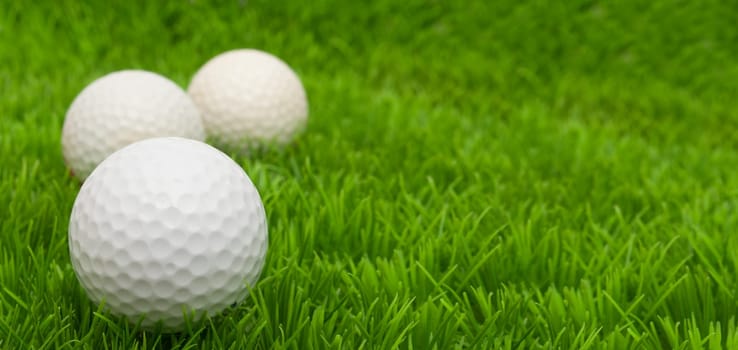 Group of Golf Balls in Green Grass